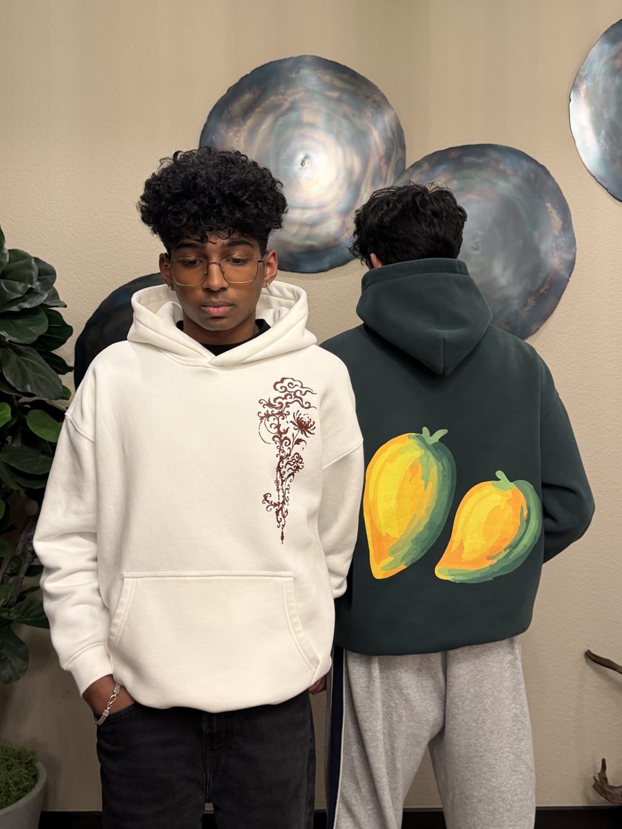 Two Nila Clothing hoodies: the cream mehndi hoodie from the front and the green mango hoodie from the back